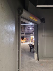 An industrial roll-up fire door in the open position. This door is a new installation located at a new warehouse in Placerville.
