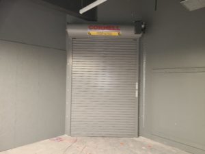 An industrial roll-up fire door in the closed position. This door is a new installation located at a new warehouse in Placerville.